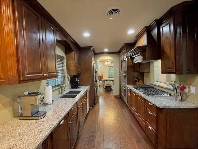 1635 W Pentagon Pkwy, Dallas, TX 75224 - kitchen with appliances with stainless steel finishes, a sink, custom exhaust hood, dark wood finished floors, and arched walkways