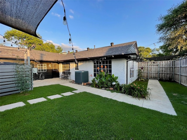 1635 W Pentagon Pkwy, Dallas, TX 75224 - rear view of property with central AC, brick siding, and a patio area