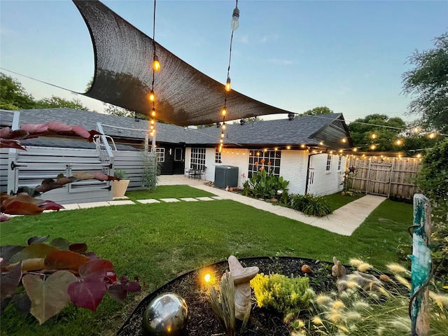 1635 W Pentagon Pkwy, Dallas, TX 75224 - back of property featuring brick siding, cooling unit, and a shingled roof