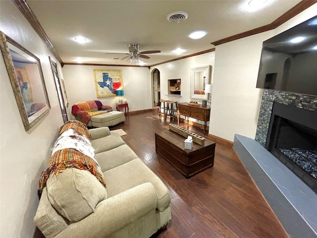 1635 W Pentagon Pkwy, Dallas, TX 75224 - living room with ornamental molding, arched walkways, a ceiling fan, wood finished floors, and a tile fireplace