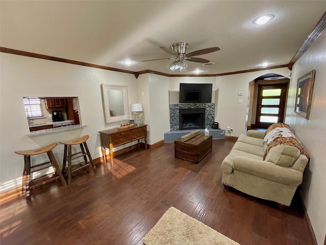 1635 W Pentagon Pkwy, Dallas, TX 75224 - living room with arched walkways, crown molding, a ceiling fan, dark wood-style floors, and recessed lighting