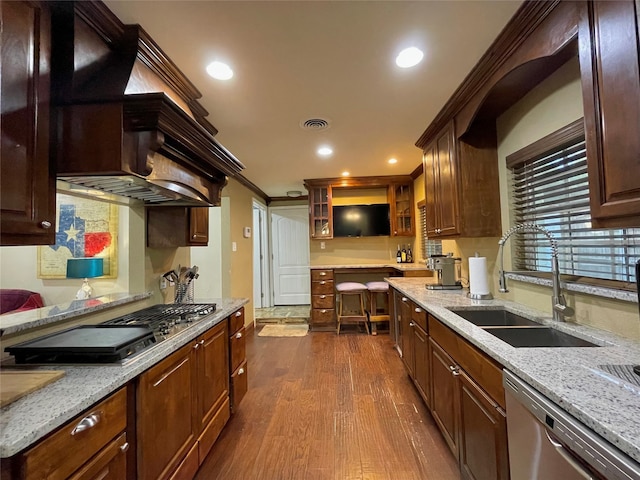 1635 W Pentagon Pkwy, Dallas, TX 75224 - kitchen featuring appliances with stainless steel finishes, a sink, dark wood-style floors, light stone countertops, and glass insert cabinets