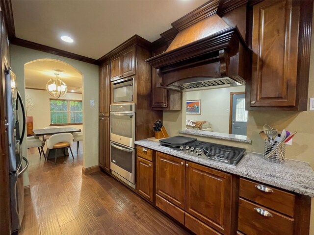 1635 W Pentagon Pkwy, Dallas, TX 75224 - kitchen featuring appliances with stainless steel finishes, dark wood-style floors, ornamental molding, arched walkways, and custom range hood