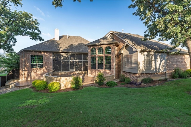437 Monarch Hill Ct, Keller, TX 76248 - back of house with brick siding, a lawn, a chimney, and a sunroom