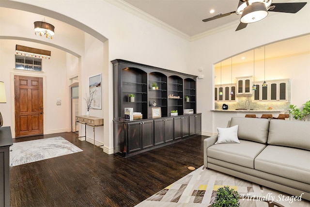 437 Monarch Hill Ct, Keller, TX 76248 - living area featuring arched walkways, a ceiling fan, dark wood-style floors, ornamental molding, and baseboards