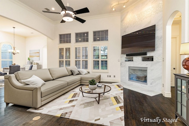 437 Monarch Hill Ct, Keller, TX 76248 - living room featuring ceiling fan, arched walkways, a premium fireplace, a chandelier, and crown molding