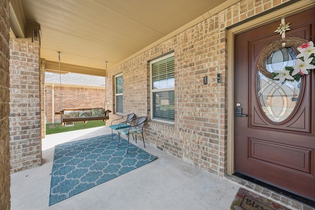 1035 Sadie St, Forney, TX 75126 - doorway to property featuring a porch and brick siding