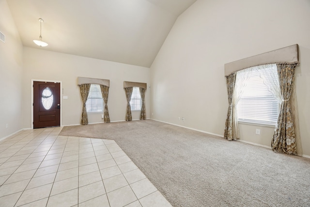 1035 Sadie St, Forney, TX 75126 - entryway featuring high vaulted ceiling, light colored carpet, baseboards, and light tile patterned floors