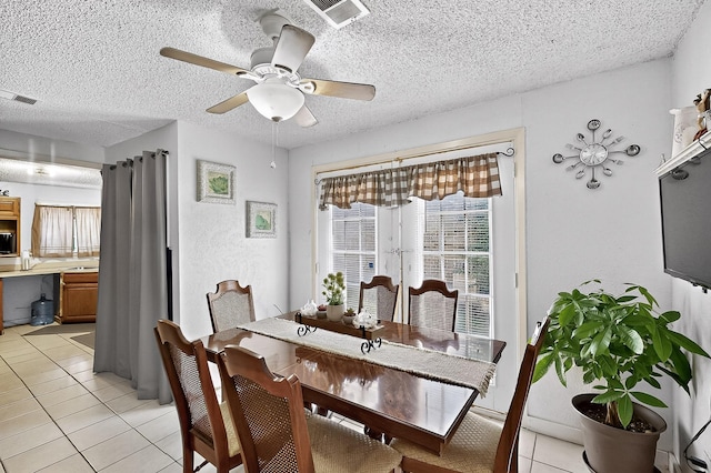 2226 Varsity Dr, Grand Prairie, TX 75051 - dining space featuring light tile patterned flooring, a ceiling fan, and a textured ceiling
