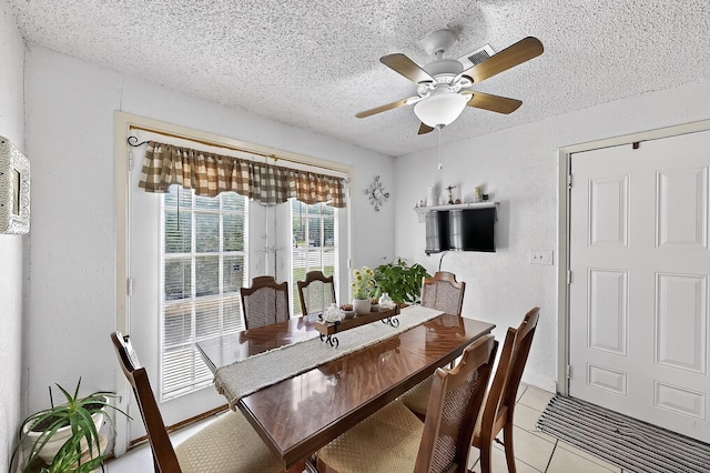 2226 Varsity Dr, Grand Prairie, TX 75051 - dining space featuring a textured ceiling, light tile patterned floors, a ceiling fan, and a textured wall