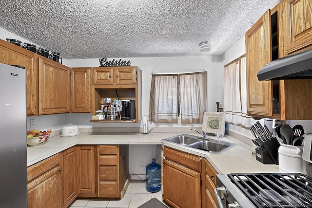 2226 Varsity Dr, Grand Prairie, TX 75051 - kitchen featuring stainless steel fridge, a sink, light countertops, light tile patterned floors, and brown cabinetry