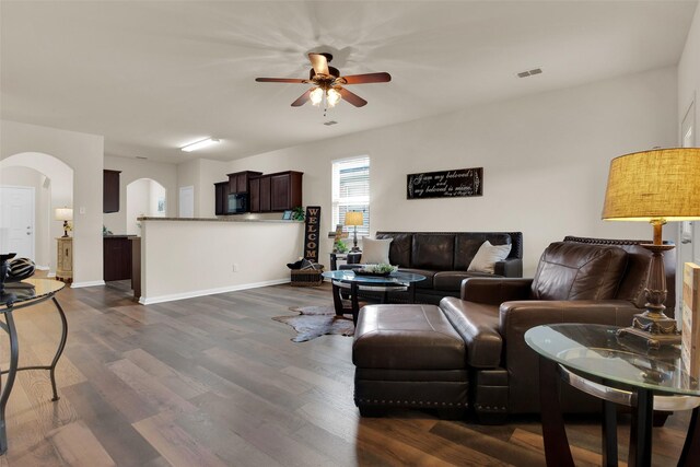 1303 Clegg St, Howe, TX 75459 - living area featuring a ceiling fan, arched walkways, dark wood-style floors, and baseboards