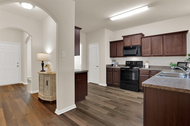 1303 Clegg St, Howe, TX 75459 - kitchen featuring black appliances, a sink, arched walkways, and dark wood-style flooring