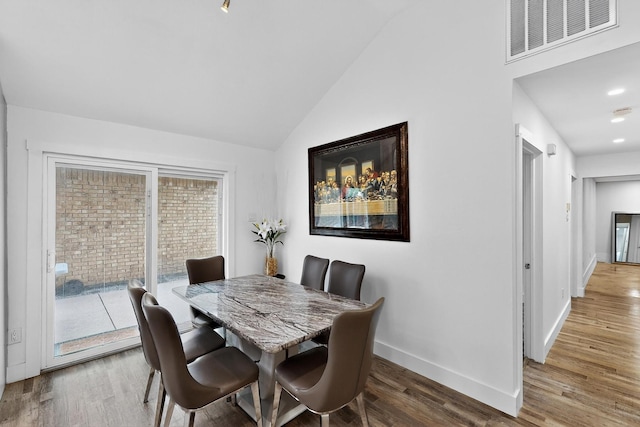 1708 Wheatfield Dr, Mesquite, TX 75149 - dining area with vaulted ceiling, wood finished floors, and baseboards