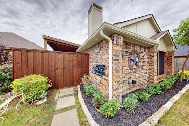 1708 Wheatfield Dr, Mesquite, TX 75149 - view of side of property with a chimney and brick siding