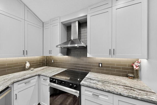 1708 Wheatfield Dr, Mesquite, TX 75149 - kitchen with wall chimney exhaust hood, electric range oven, white cabinetry, backsplash, and lofted ceiling