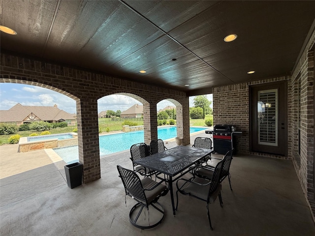 321 Bear Country Dr, Aledo, TX 76008 - view of patio with grilling area, outdoor dining area, and a pool with connected hot tub