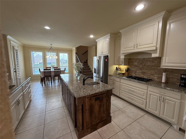 321 Bear Country Dr, Aledo, TX 76008 - kitchen featuring stainless steel fridge, gas cooktop, a sink, decorative backsplash, and light stone counters