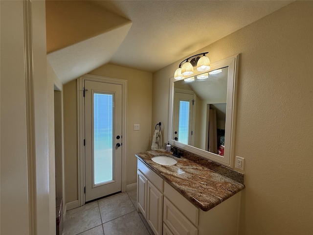 321 Bear Country Dr, Aledo, TX 76008 - bathroom with vaulted ceiling, vanity, healthy amount of natural light, and tile patterned floors