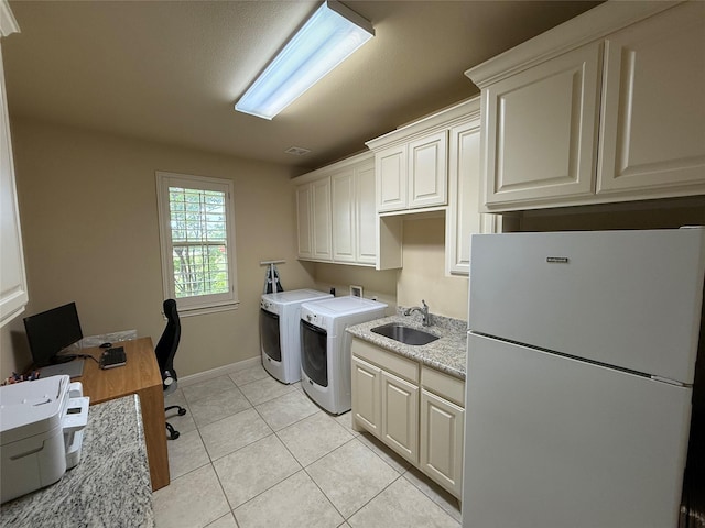 321 Bear Country Dr, Aledo, TX 76008 - laundry room featuring cabinet space, washer and clothes dryer, baseboards, light tile patterned floors, and a desk