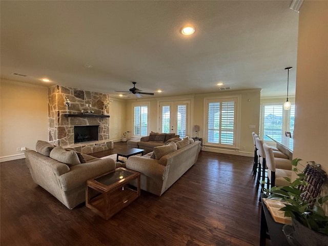 321 Bear Country Dr, Aledo, TX 76008 - living area featuring crown molding, dark wood-style floors, baseboards, a ceiling fan, and a stone fireplace