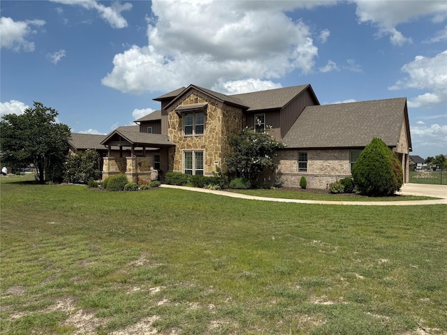 321 Bear Country Dr, Aledo, TX 76008 - view of front of house with a front lawn, stone siding, and roof with shingles