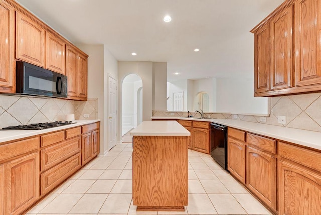 3232 Kent Dr, Flower Mound, TX 75022 - kitchen featuring black appliances, arched walkways, a center island, tasteful backsplash, and recessed lighting