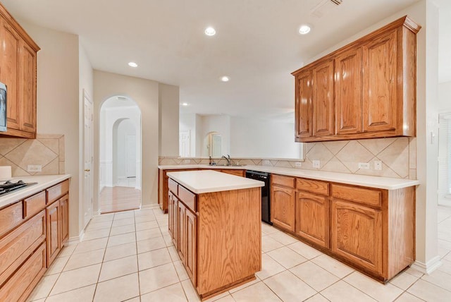 3232 Kent Dr, Flower Mound, TX 75022 - kitchen featuring dishwasher, arched walkways, a kitchen island, decorative backsplash, and light countertops