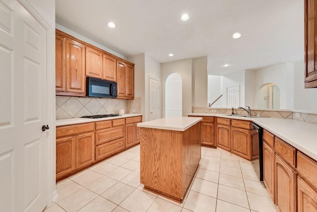 3232 Kent Dr, Flower Mound, TX 75022 - kitchen featuring black appliances, tasteful backsplash, recessed lighting, light countertops, and arched walkways