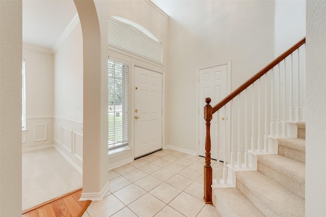 3232 Kent Dr, Flower Mound, TX 75022 - entryway with healthy amount of natural light, ornamental molding, stairs, and arched walkways