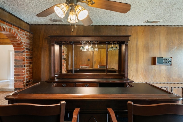 110 S Capri Dr, Duncanville, TX 75116 - detailed view of a ceiling fan, a textured ceiling, arched walkways, and wooden walls