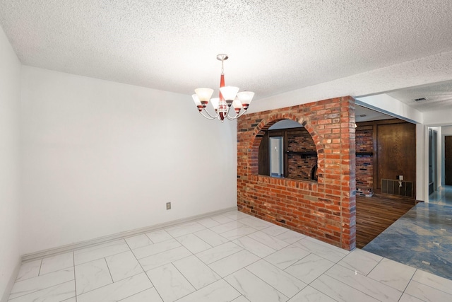 110 S Capri Dr, Duncanville, TX 75116 - spare room featuring marble finish flooring, a chandelier, and a textured ceiling