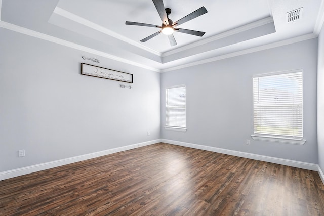 207 Morning Mist Trl, Abilene, TX 79602 - empty room featuring a tray ceiling, healthy amount of natural light, dark wood finished floors, a ceiling fan, and ornamental molding