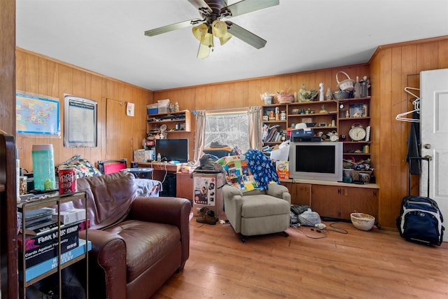 303 E Broadway St, Prosper, TX 75078 - living area featuring wood walls, wood finished floors, and ceiling fan