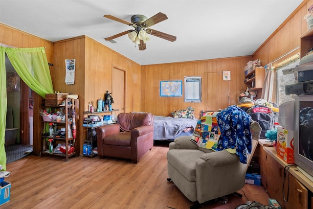 303 E Broadway St, Prosper, TX 75078 - living room featuring a ceiling fan, wood walls, wood finished floors, and crown molding