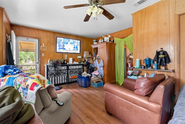 303 E Broadway St, Prosper, TX 75078 - living area with wooden walls, ceiling fan, and wood finished floors