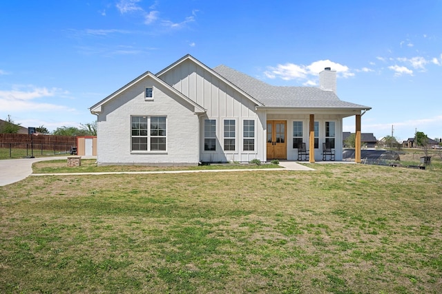 7954 Lax Dr, Fort Worth, TX 76126 - rear view of property with board and batten siding and a chimney
