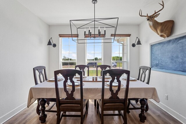 7954 Lax Dr, Fort Worth, TX 76126 - dining space with healthy amount of natural light, wood finished floors, a chandelier, and baseboards
