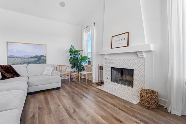 7954 Lax Dr, Fort Worth, TX 76126 - living area featuring wood finished floors, a tiled fireplace, and high vaulted ceiling