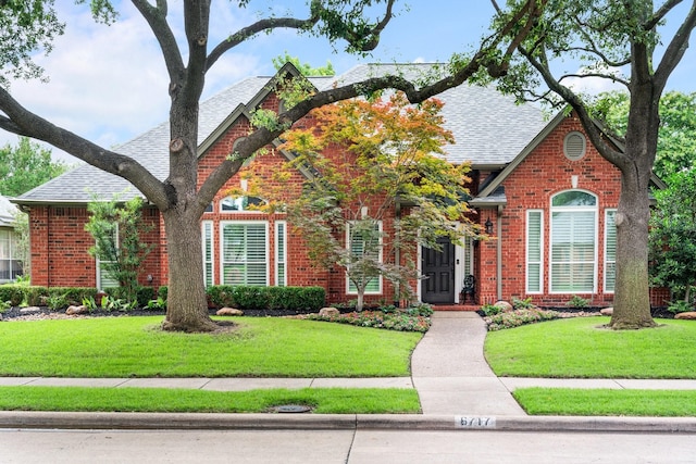 6717 Alcove Ln, Plano, TX 75024 - view of front facade with a shingled roof, a front yard, and brick siding