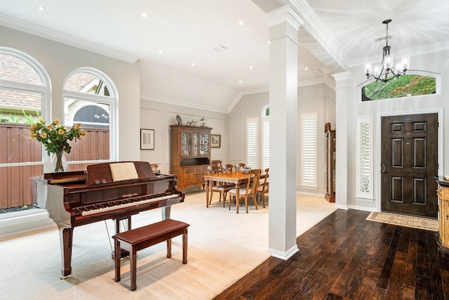 6717 Alcove Ln, Plano, TX 75024 - foyer with ornamental molding, decorative columns, a chandelier, wood finished floors, and lofted ceiling