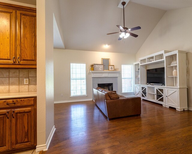 258 Pecan Hollow Cir, Anna, TX 75409 - living area with a ceiling fan, dark wood-style floors, a fireplace, and high vaulted ceiling