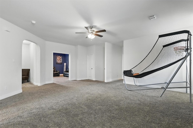 14825 Complacent Way, Aledo, TX 76008 - unfurnished living room with arched walkways, carpet floors, a ceiling fan, and baseboards