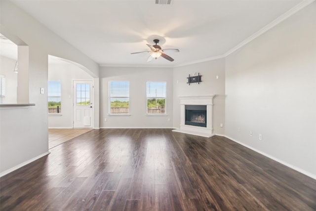 6321 Stone Lake Dr, Fort Worth, TX 76179 - unfurnished living room featuring healthy amount of natural light, a ceiling fan, wood finished floors, a fireplace with raised hearth, and ornamental molding