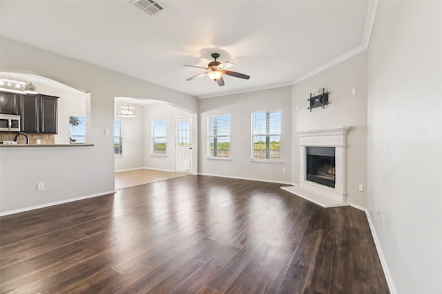 6321 Stone Lake Dr, Fort Worth, TX 76179 - unfurnished living room featuring ceiling fan, wood finished floors, a fireplace with raised hearth, baseboards, and ornamental molding