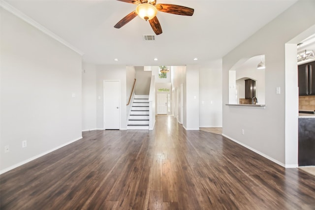 6321 Stone Lake Dr, Fort Worth, TX 76179 - unfurnished living room with a ceiling fan, stairs, dark wood-type flooring, baseboards, and arched walkways