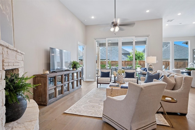3228 Zenyatta Ct, Celina, TX 75009 - living area with a ceiling fan, a stone fireplace, light wood-style flooring, recessed lighting, and baseboards