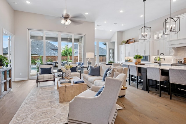 3228 Zenyatta Ct, Celina, TX 75009 - living room featuring light wood-type flooring, a chandelier, ceiling fan, and recessed lighting