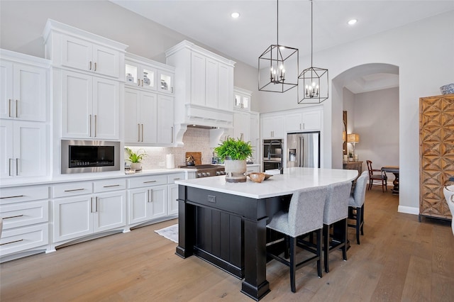3228 Zenyatta Ct, Celina, TX 75009 - kitchen featuring appliances with stainless steel finishes, arched walkways, white cabinetry, and recessed lighting