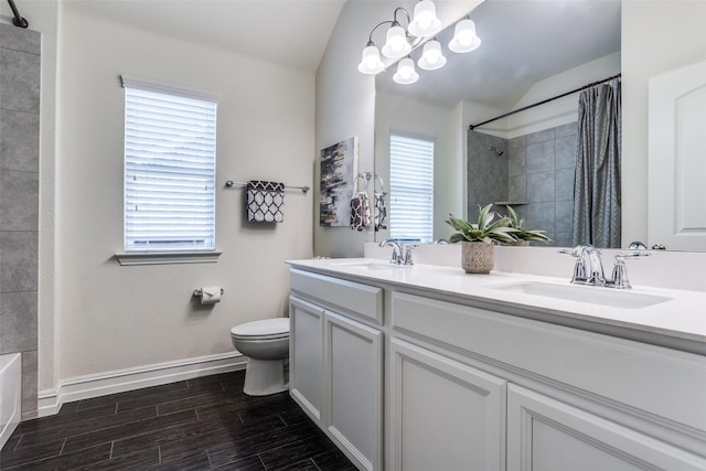 1814 Indigo Creek Ln, Wylie, TX 75098 - bathroom featuring toilet, double vanity, vaulted ceiling, wood finished floors, and baseboards